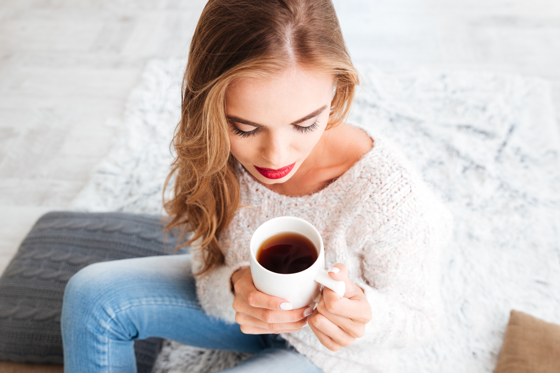Woman with flowing hair holding a coffee mug
